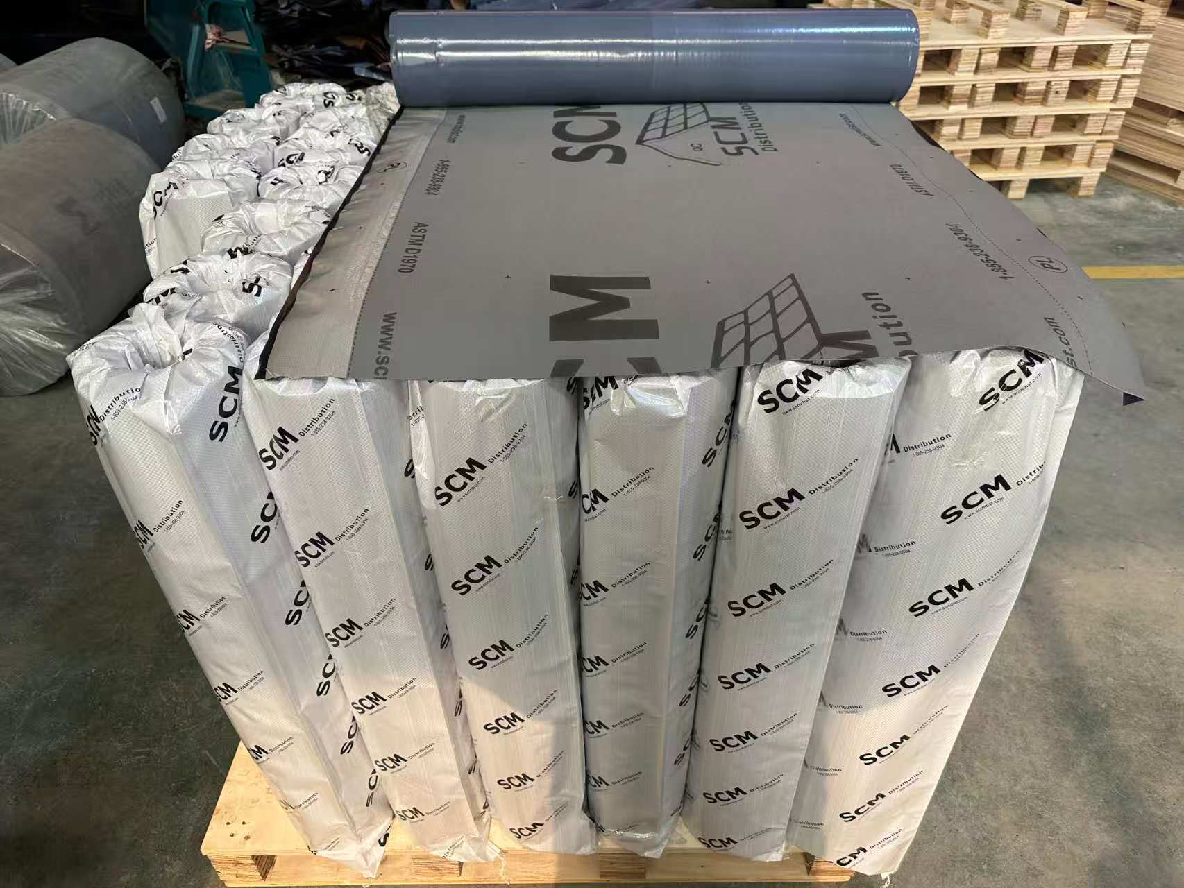 Grey membrane roll opened on packaged rolls